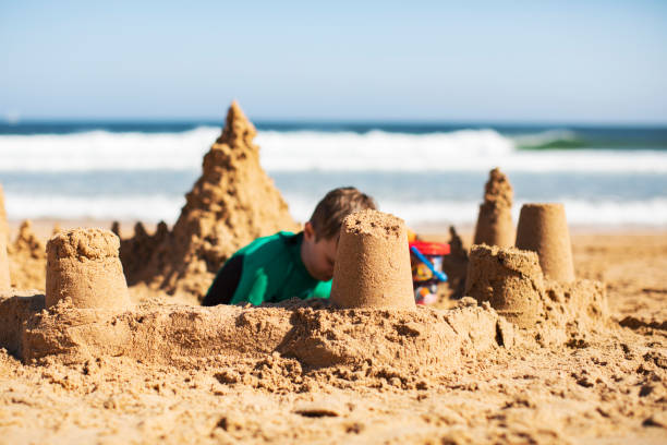 istock Kids building sand castle 1153031375