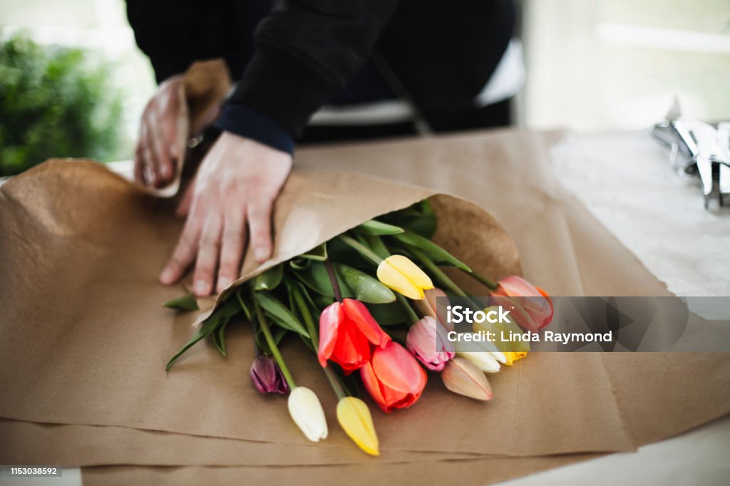 Bunch of rainbow tulips in brown paper wrap flower, bouquet, wrapping, springtime Florist Stock Photo