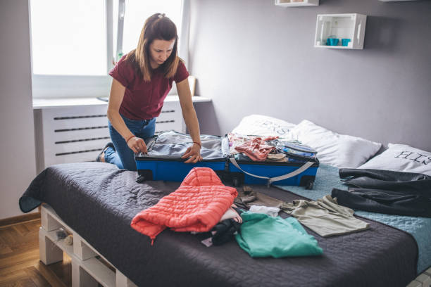 istock Woman packing clothes in suitcase 1153038725