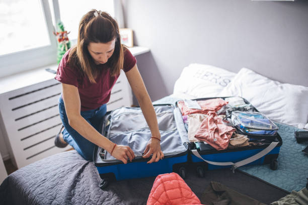 istock Woman packing her suitcase 1153039641