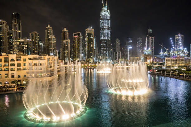 Dubai Fountains, Dubai, UAE Dancing fountains at the foot of the worlds tallest building in Dubai. dubai mall outside stock pictures, royalty-free photos & images