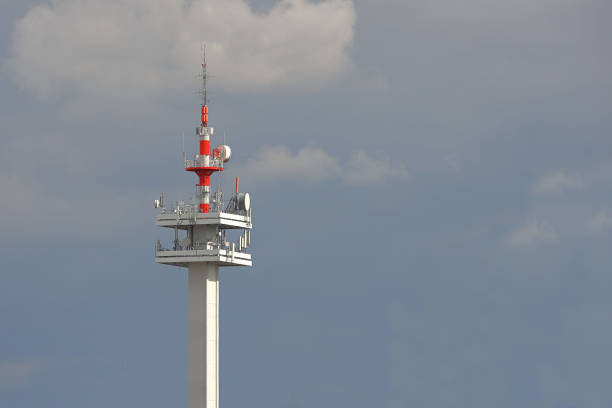 Radio tower with antennas on a blue sky background. Metal construction. Wireless network. Transmit tv radio signal. Egology of the environment. Information digitalization and high technology.