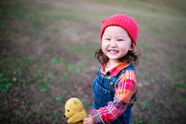 Girl playing with a teddy bear