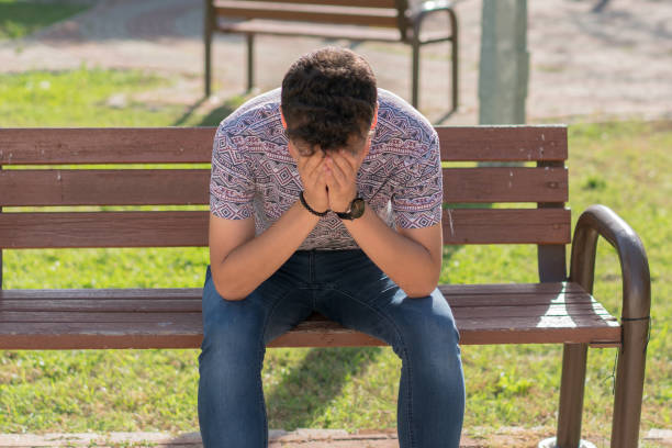 istock Sad young men on the  park bench 1153041602