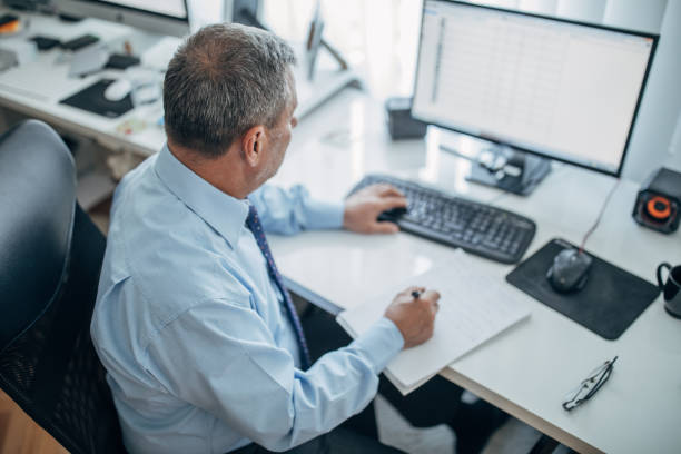 istock Senior businessman working at the office 1153042328