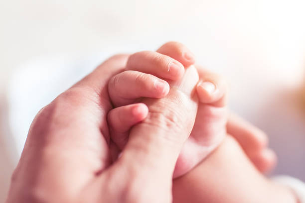 istock Newborn hand holds hand of his father 1153045372