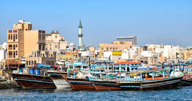 Traditional wooden Dhows moored on the creek in Dubai in the district Deira Traditional wooden Dhows moored on the creek in Dubai in the district Deira (United Arab Emirates) dhow photos stock pictures, royalty-free photos & images