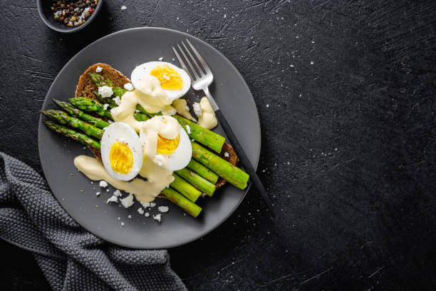 istock Tasty toasts with asparagus, eggs and sauce 1153046529