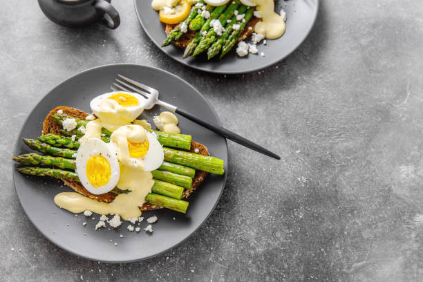 istock Tasty toasts with asparagus, eggs and sauce 1153047150