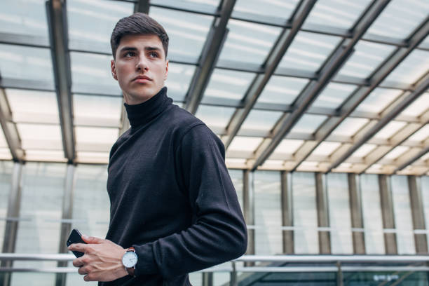 istock Attractive man holding smart phone 1153047590
