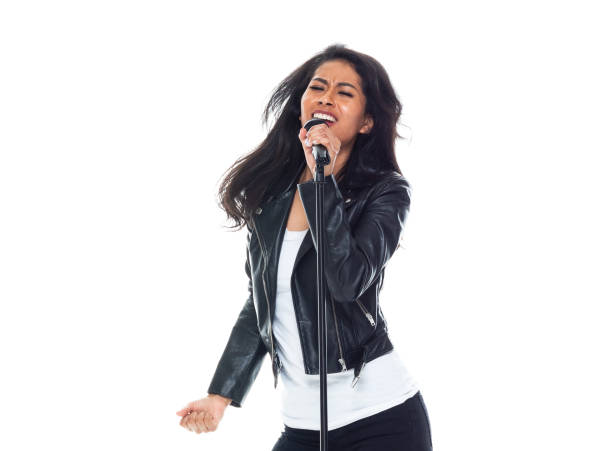 istock Bautiful woman wearing a leather jacket and singing like a rock star 1153047608