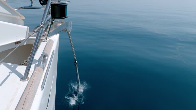 MS Super slow motion hand dropping anchor off sailboat