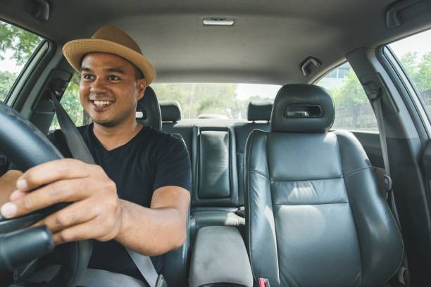 istock Young handsome asian man driving car 1153053204