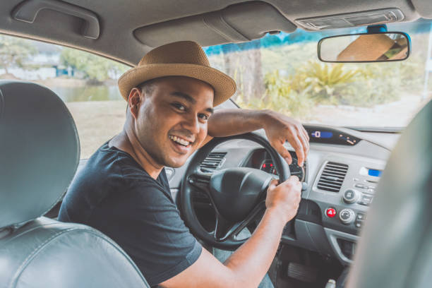 istock Young handsome asian man driving car 1153053319