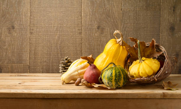 istock Autumn harvest background with pumpkin and squash on wooden table. 1153053402