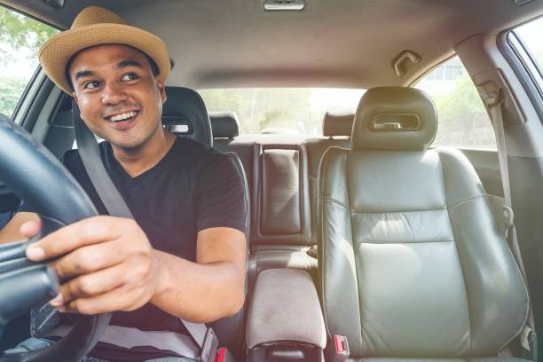 istock Young handsome asian man driving car 1153053536