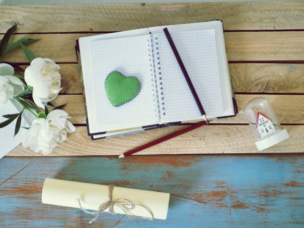 istock Books, blank notebook, paper, glasses on a wooden table, top view 1153054136