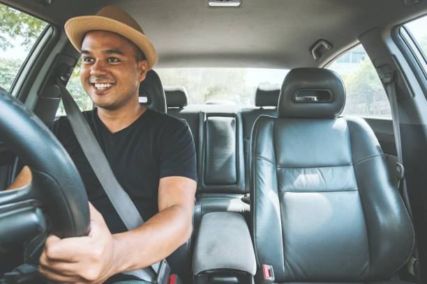 istock Young handsome asian man driving car 1153054518