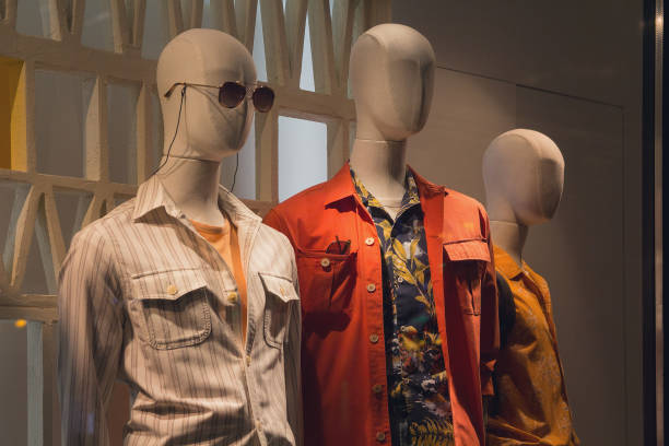 istock Men's dummies in the store window and city reflections 1153054700