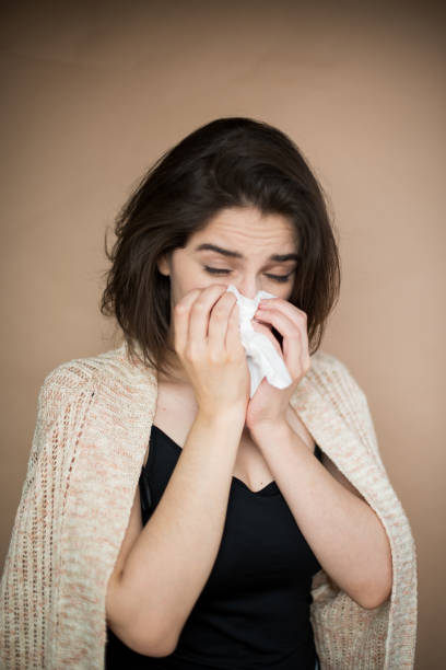 istock Young woman with flu virus symptom. 1153054796