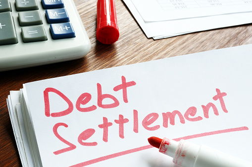 Debt Settlement handwritten on loan documents.