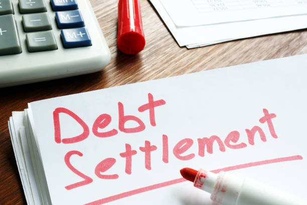 Debt Settlement handwritten on loan documents. Debt Settlement handwritten on loan documents. human settlement stock pictures, royalty-free photos & images