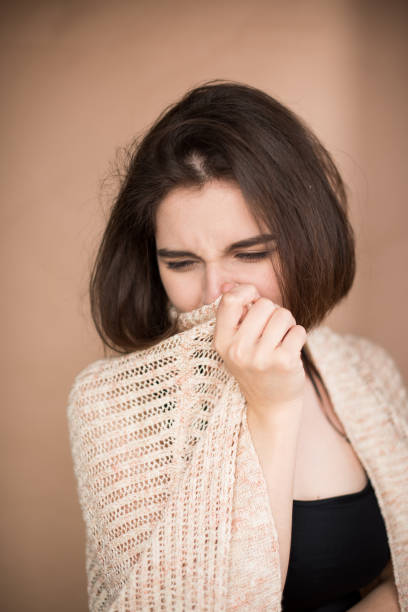 istock Young woman cover mouth after sneezing. 1153055749