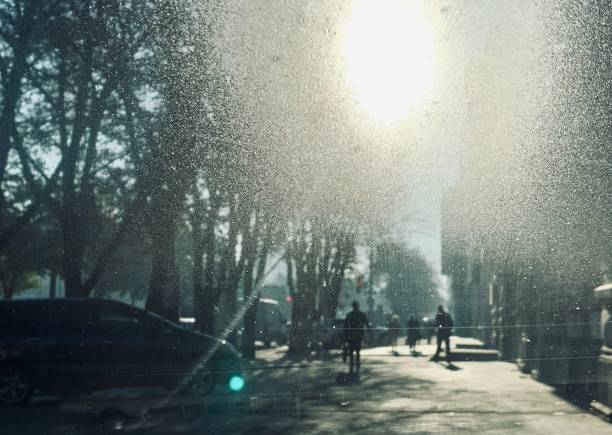 istock Snowing. Snow on the window car. Blurred people on the background 1153057033