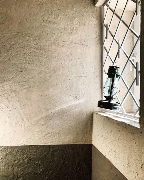 istock vintage luminaire on the window with grating 1153057065