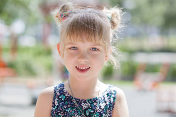 istock Young blond girl posing outdoors 1153059870