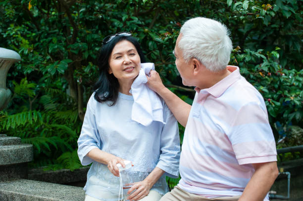 istock Lovely senior couple taking break and having conversation after exercising in park 1153060963