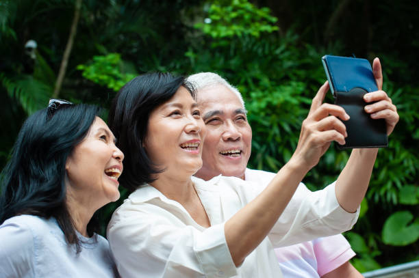 istock Senior adults having fun taking selfie in the park 1153061116