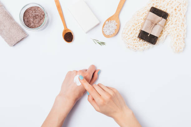 istock Woman's hands apply cosmetic cream next to bath accessories 1153061253