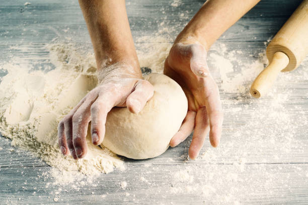 istock Cook hands knead the dough.Close-up. 1153062298