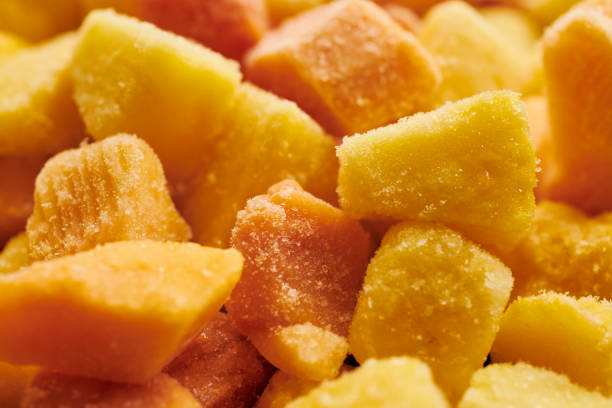 close up of frozen mango, papaya and pineapple chunks. stock photo
