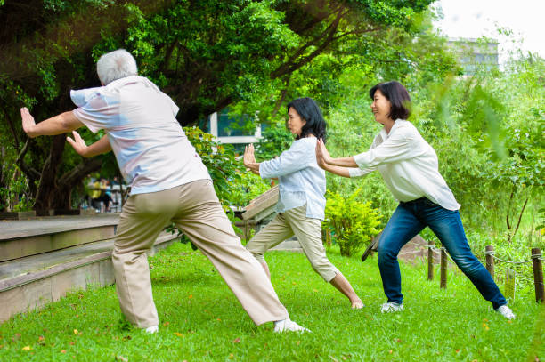 istock Senior adults practising Tai Chi in the park 1153063417