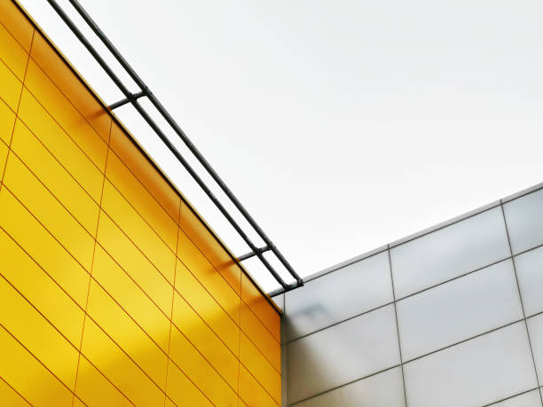istock Low Angle View of Yellow and Silver Tiled Walls Against Sky 1153064564