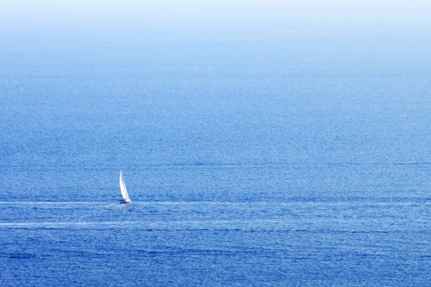 istock Lonely sailing yacht on background of blue sea 1153069607