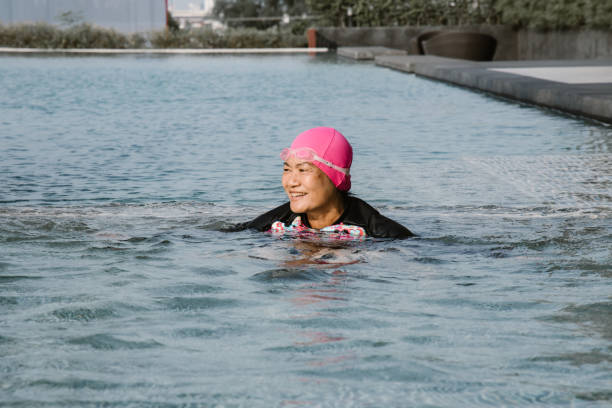 istock Thai elderly woman in pool - Stock image 1153075826