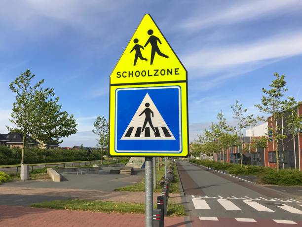 istock Road sign warning for a school zone 1153077446