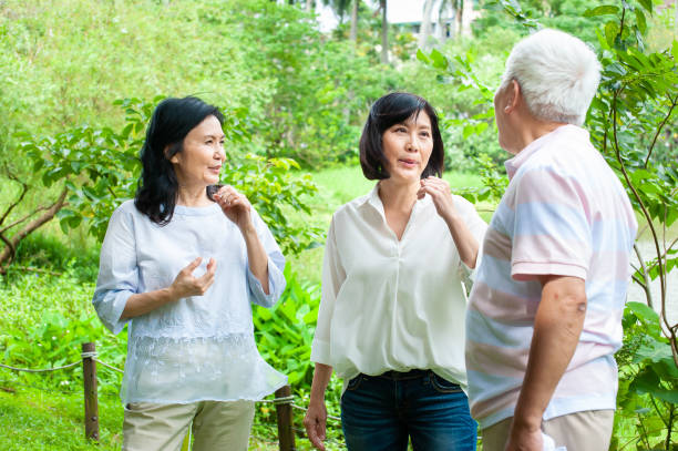 istock Senior adults having short break after exercise in park 1153083492