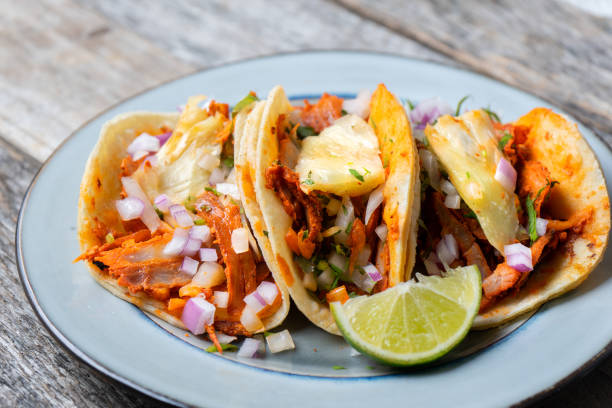 istock Mexican food: Authentic tacos al pastor with lime and pineapple 1153084095