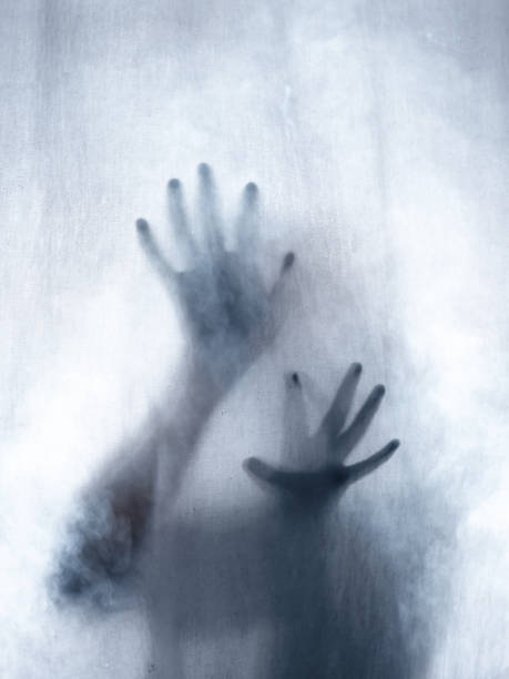 istock Screaming human pressing through fabric curtain as horror background . Trapped in shadows 1153088081