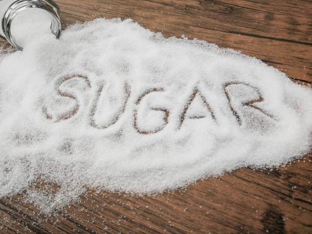istock white sugar on wood table with sugar spread and written text . 1153088399