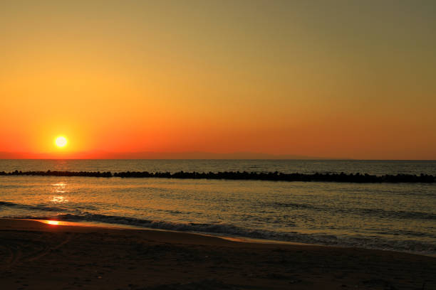 sunset at Japan sea and Sado island, view from Niigata, Japan sunset at Japan sea and Sado island, view from Niigata, Japan Sado stock pictures, royalty-free photos & images