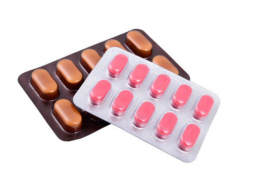 brown and pink medicine pack isolated on white background