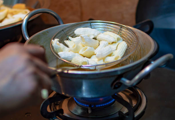 istock Frying snacks indian style in hot oil in pan with hands 1153096605