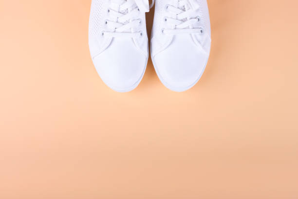 istock white sneakers on color background. copy space. 1153100115