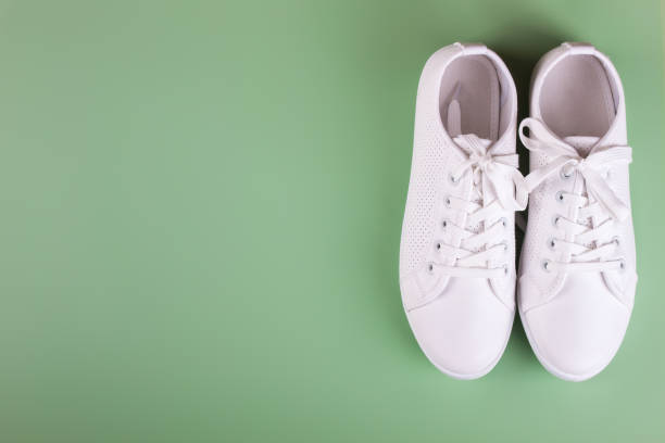 istock white sneakers on color background. copy space. 1153100290