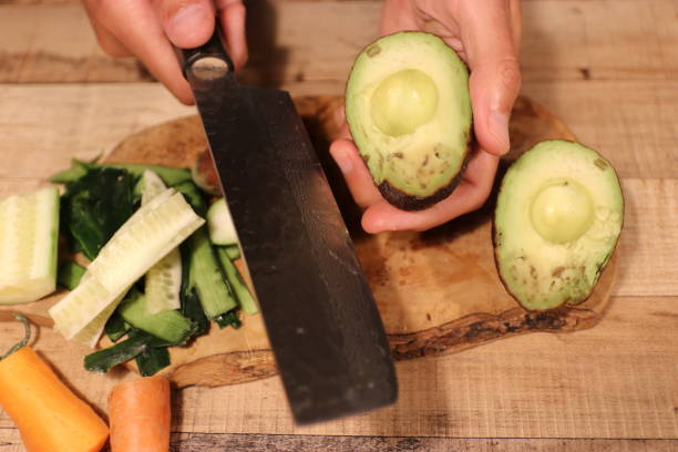 istock Pealing and cutting vegetables for sushi dinner cucumber avocado carrot 1153108586